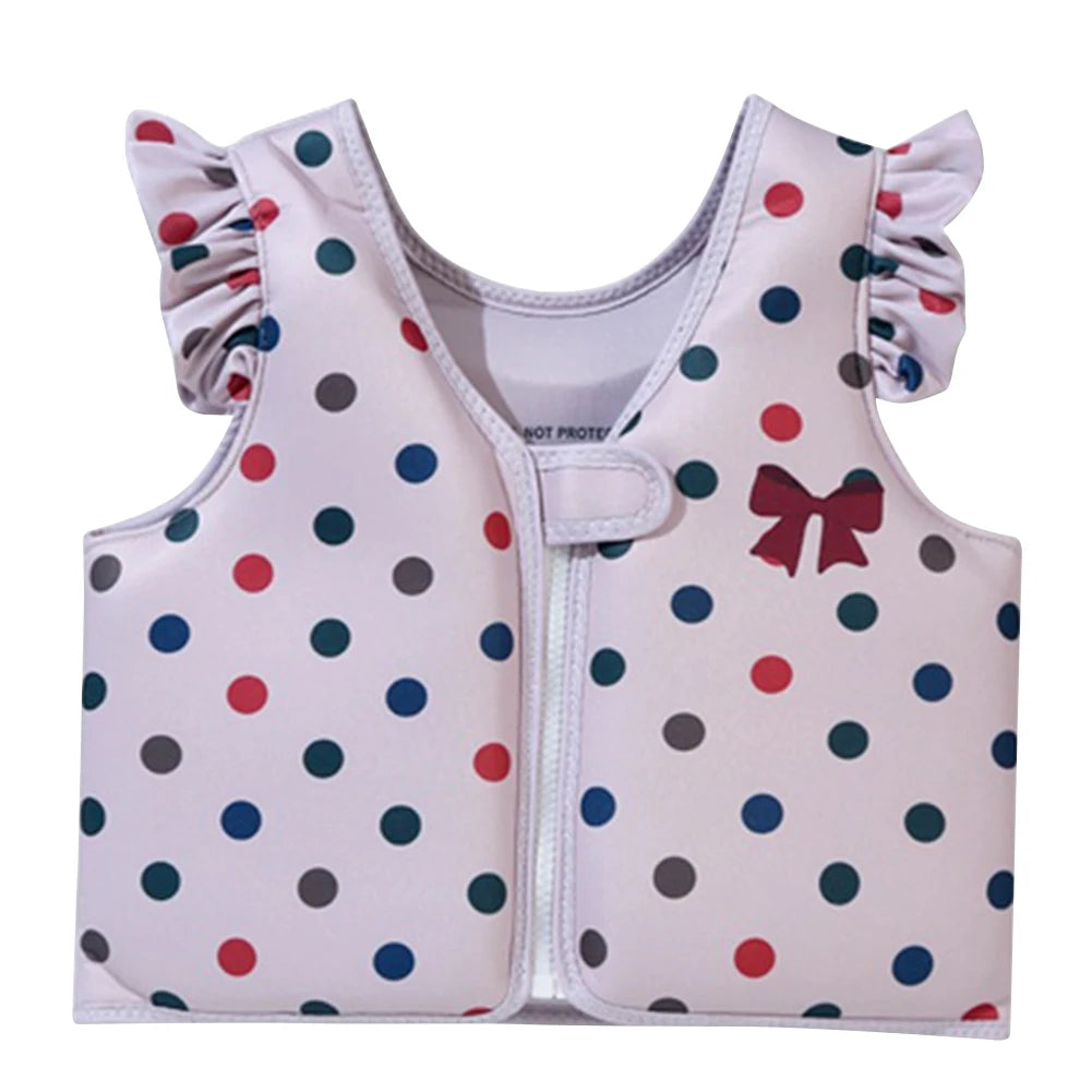 Baby safety vest with polka dot pattern and bow design on a white background