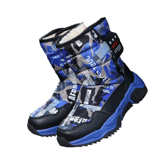 Blue and black patterned winter boots held by a child against a white background