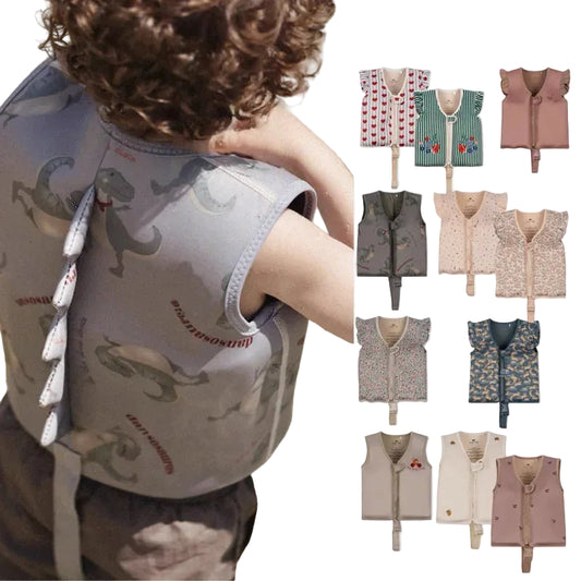 Child wearing a dinosaur-patterned vest with a side view, surrounded by various other vests.