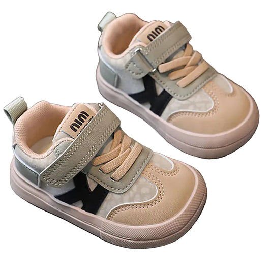 Pair of children's sneakers with velcro straps on a white surface