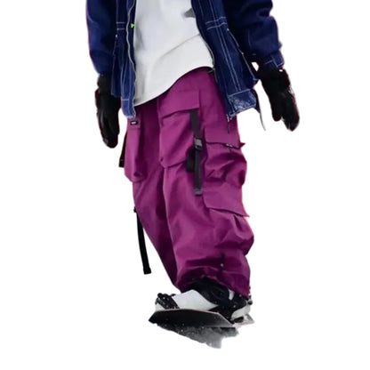 Person snowboarding with purple pants and a white background