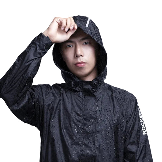 Person wearing a black raincoat on a dark background