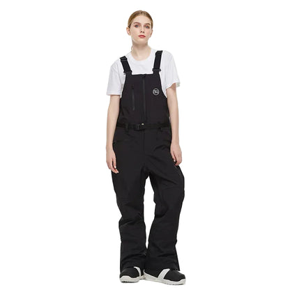 Person wearing black bib overalls on a white background