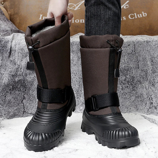 Person wearing black snow boots with brown leg covers on a snowy ground.