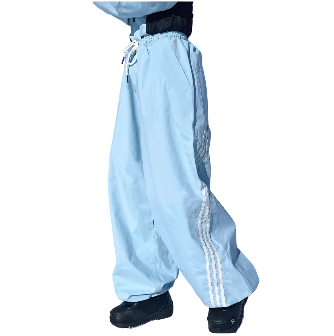 Person wearing light blue snow pants with white stripes on a snowy landscape.