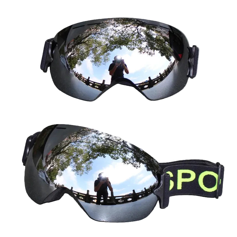 Reflective goggles on a white surface.