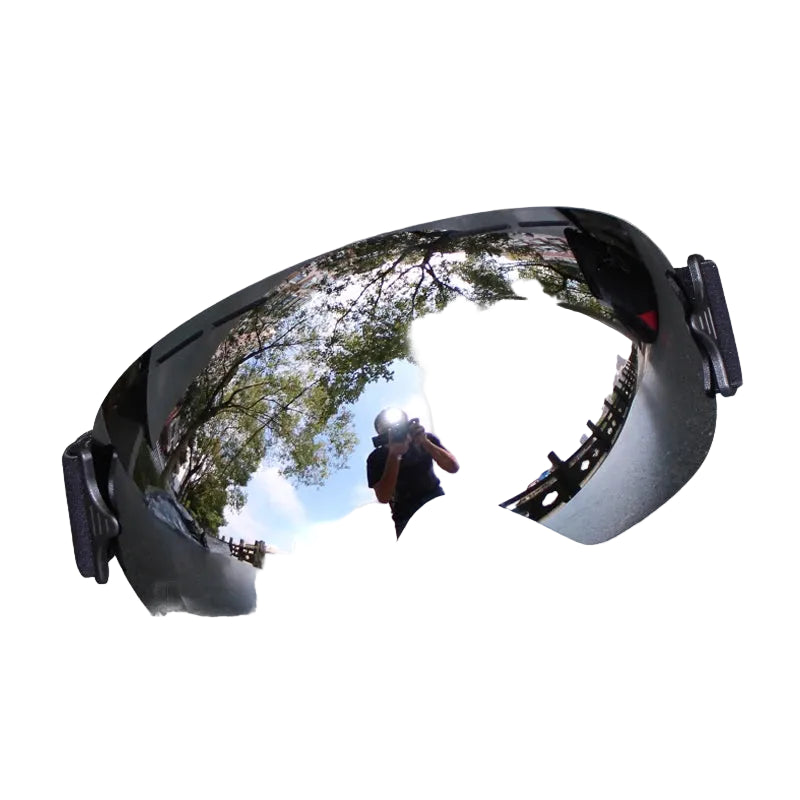 Reflective goggles on snow with a person taking a photo in the reflection