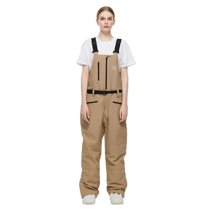 Person wearing a beige bib overalls on a white background