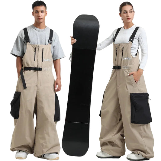 Two people wearing beige snow pants with black accents, holding a black snowboard.