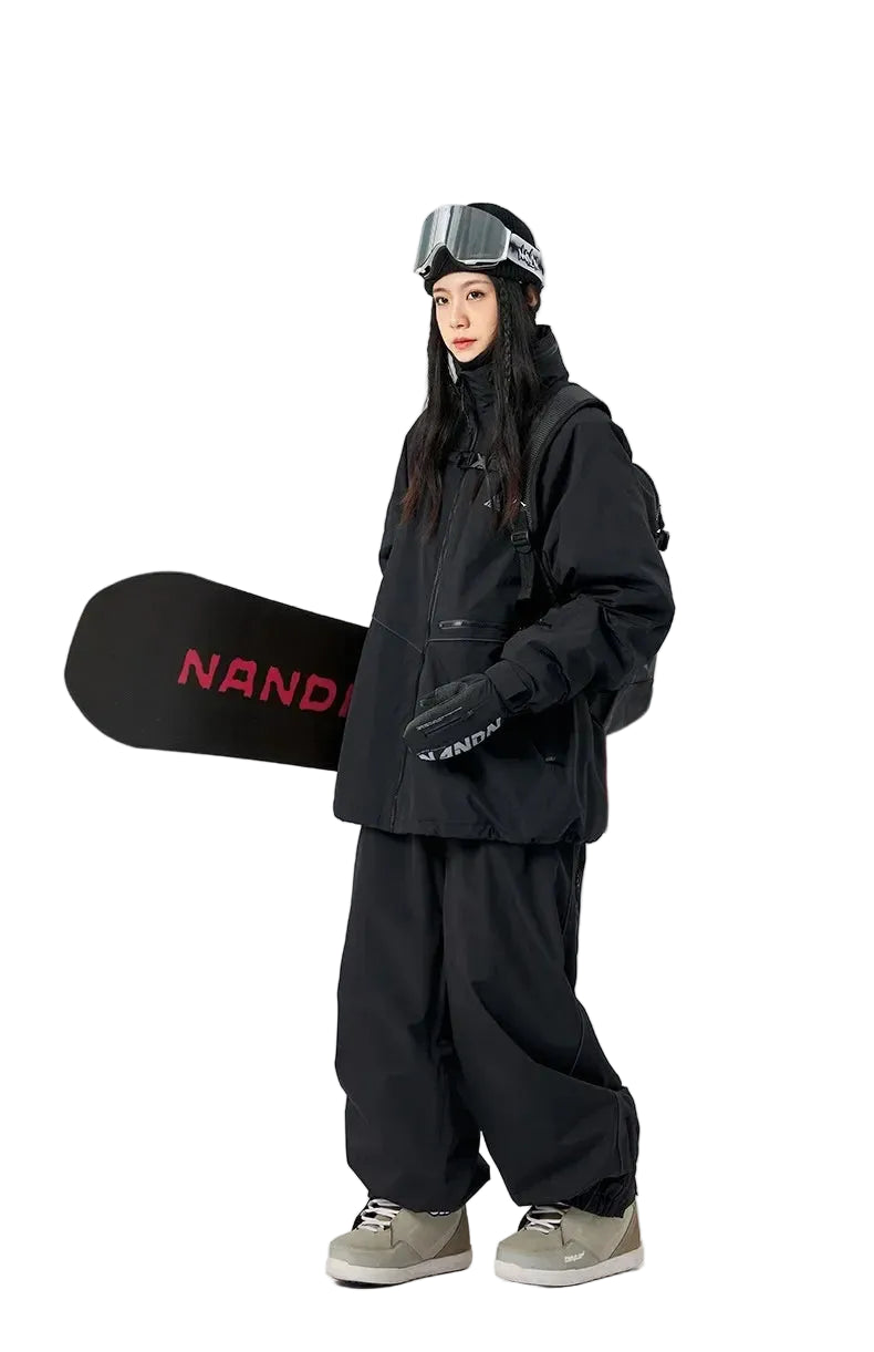 Person wearing black snowboarding gear holding a black snowboard with red text on a white background