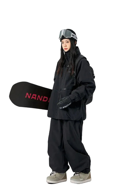 Person wearing black snowboarding gear holding a black snowboard with red text on a white background