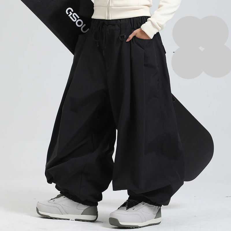 Person wearing black wide-leg pants with a white background