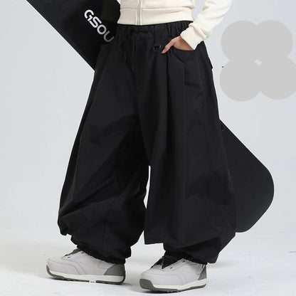 Person wearing black wide-leg pants with a white background