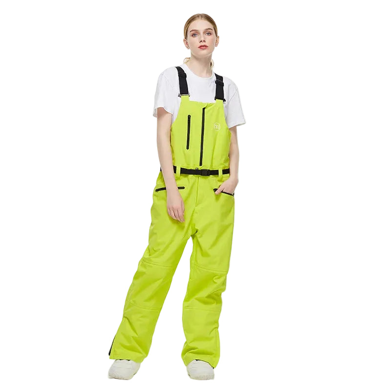 Person wearing bright green ski bibs on a white background