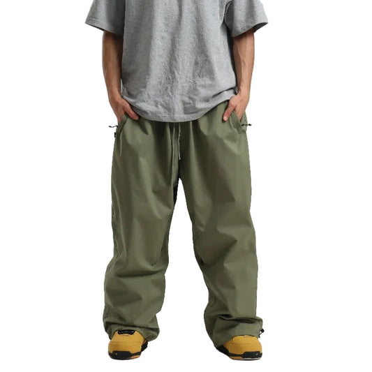 Person wearing green pants and a gray shirt on a white background