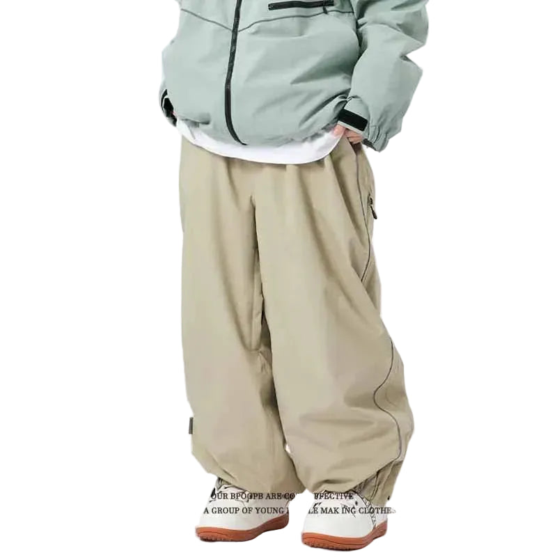 Person wearing a light gray jacket, white shirt, beige pants, and brown shoes on a white background 