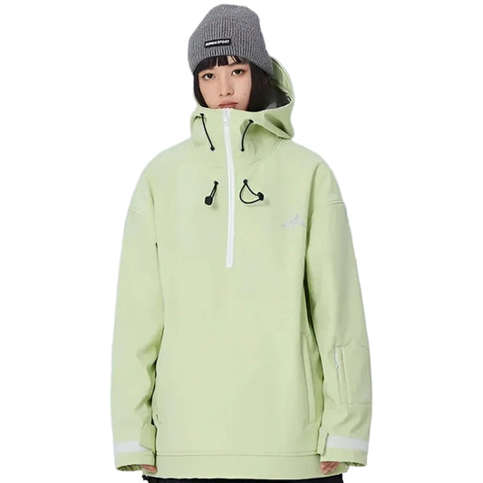 Person wearing a light green jacket and gray beanie standing in a with white mountains.