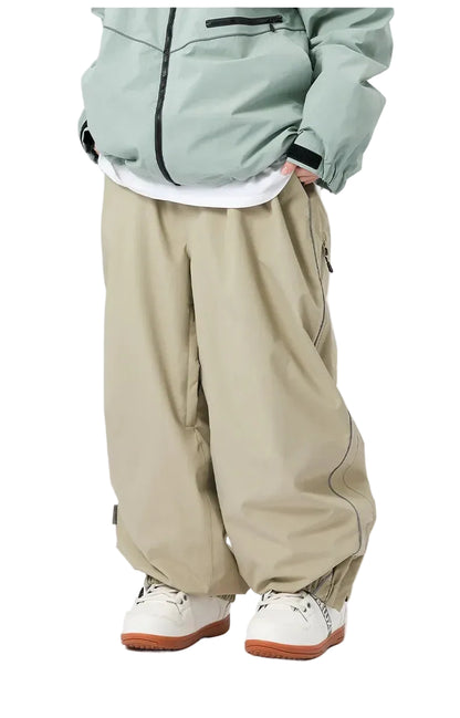 Person wearing a light green jacket, white shirt, beige pants, and white sneakers on a white background