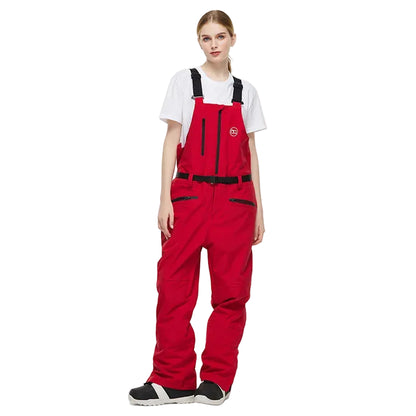 Person wearing a red snowmobile bib overalls on a white background